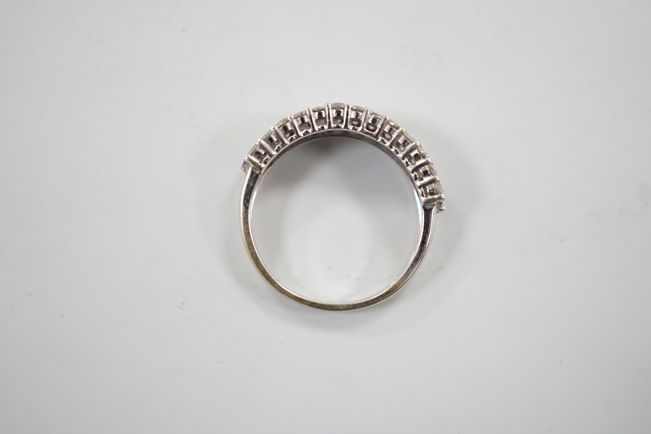 A modern 750 white metal, sapphire and diamond set three row half hoop ring, size M, gross weight 2.5 grams.